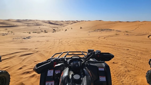 Rider’s view over the handlebars of a quad heading into the Erg Chebbi dunes