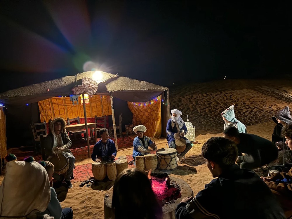 Gnawa drum music around a fire at night in Merzouga